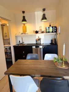 a kitchen with a wooden table and chairs at Granastaðir Guesthouse in Granastaðir