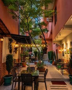 a courtyard with tables and chairs in a building at Marani Hotel in Batumi