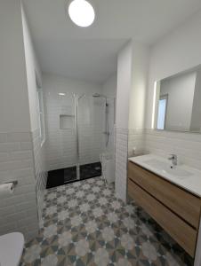 a bathroom with a sink and a shower and a toilet at Alojamientos Bahia de Santoña 4 in Santoña +11 photos