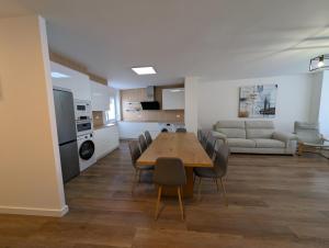 a dining room and living room with a table and chairs at Alojamientos Bahia de Santoña 4 in Santoña