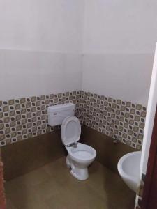 a bathroom with a toilet and a sink at Atlas blue hotel in Bathinda
