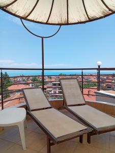 two chairs on a balcony with a view at Hotel Andre in Burgas +14 photos