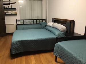 a room with three beds and a table at My house in Turin
