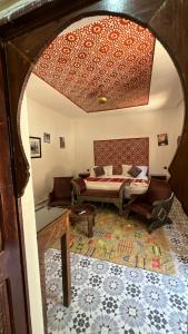 a bedroom with a bed and a couch in a room at Oloft in Marrakesh