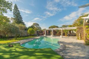 an estate with a swimming pool in a yard at The Valley Escape - Executive Suite in Gqeberha