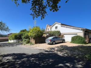 a car parked in the driveway of a house at Maison d'Hôtes L'Escale Du Loup Blanc in Maringes