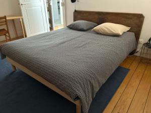 a bed with two pillows on it in a bedroom at BELISAMA in Molsheim