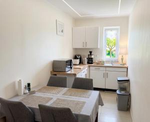 a kitchen with a table and chairs in a room at Pension Rialto in Staufenberg