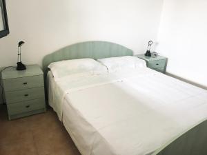 Giường trong phòng chung tại Camping Porto Miggiano