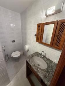 a bathroom with a sink and a toilet and a mirror at Hotel Buriti da Serra in Itaipava +45 photos