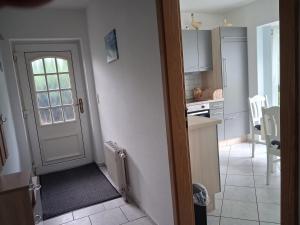 a kitchen with a door leading to a kitchen with a counter at Ferienwohnung Silvia in Steinhagen