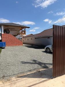 a car parked in a parking lot in front of a building at Guesthouse Bârlogul Balaurului in Afumaţi