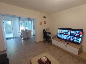 a living room with a large flat screen tv at Apartments Emi & Nini in Šibenik