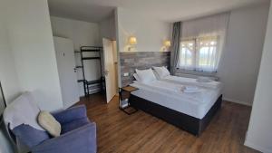 a bedroom with a bed and a chair in it at Casa Comilor in Şurdeşti