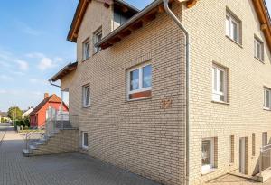 a brick building with stairs on the side of it at Pension Rialto in Staufenberg