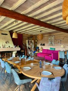 a large wooden table and chairs in a living room at L'Abeille-Vie in Tréziers
