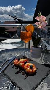 a plate of food on a table with a drink at Hotel Elena Solotvino in Solotvyno