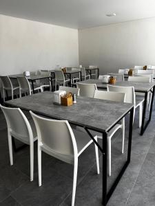 a dining room with tables and white chairs at Hotel Elena Solotvino in Solotvyno +56 photos