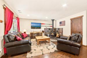 a living room with two leather couches and a table at The Rustic Pine 2BDR Cabin in Tahoma +26 photos