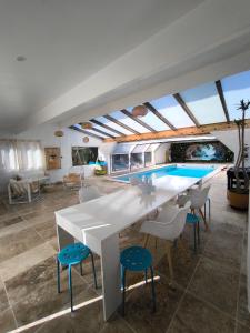 a kitchen with a table and chairs and a swimming pool at Les gîtes de Vensac in Vensac