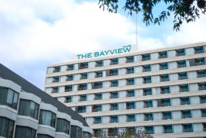 a hotel building with the bayview sign on top at The Bayview Hotel Pattaya in Pattaya
