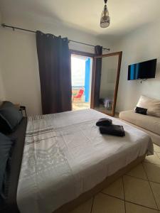 a bedroom with a large bed and a mirror at Appart hôtel Cabo dream in Cabo Negro +26 photos