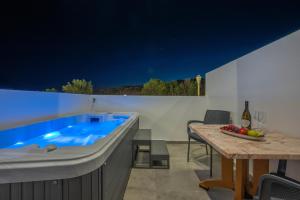 a kitchen with a hot tub and a table with a tableablish at Prasonisi Lighthouse Asimenis in Prasonisi