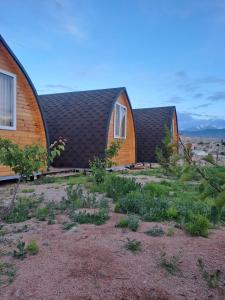 a group of homes with a roof at "AILUN" Issyk Kul in Tong
