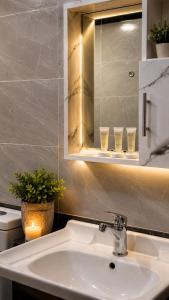 a bathroom with a sink and a mirror and glasses at WADI RUM ROTANA BUBBLE lUXURY in Wadi Rum