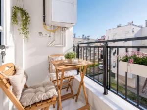 a balcony with a wooden table and chairs on a balcony at Maxihomes Elissa in Antalya
