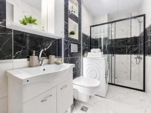 a bathroom with a toilet and a sink and a shower at Maxihomes Elissa in Antalya