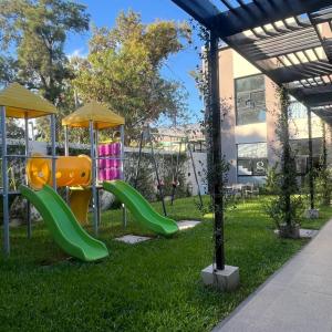 a playground with a slide in the grass at Hotel Boutique Gualamba in General Pinedo
