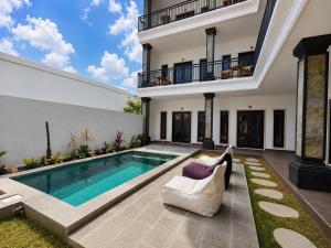 a swimming pool in the backyard of a house at Padmasari Guest House in Canggu