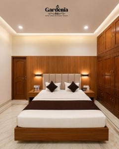 a bedroom with a large bed and wooden cabinets at Hotel gardenia inn in Gwalior