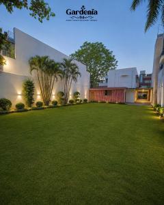 a large lawn in front of a building at Hotel gardenia inn in Gwalior