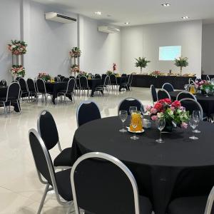 a black table with wine glasses and flowers in a room at Hotel Boutique Gualamba in General Pinedo +87 photos