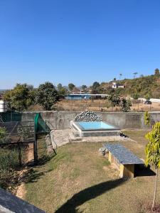 a backyard with a swimming pool at Dalipfarm River View Guestroom in Surajpur
