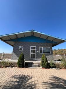 a house with a roof on a brick driveway at Dalipfarm River View Guestroom in Surajpur