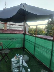 a large umbrella sitting on top of a roof at Apartman M&D in Pančevo
