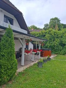 a patio with a table and chairs in a yard at Őrségi Csónakház in Hegyhátszentjakab