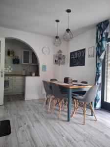 a kitchen and dining room with a table and chairs at Őrségi Csónakház in Hegyhátszentjakab