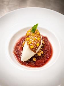 a white plate of food with a dessert on it at Hotel-Restaurant Peifer in Brodenbach