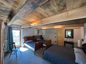 a bedroom with two beds and a desk in it at Riverside Room Elia Family friendly apartment in Pontboset
