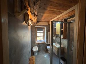 a bathroom with a toilet and a sink at Riverside Room Elia Family friendly apartment in Pontboset +23 photos