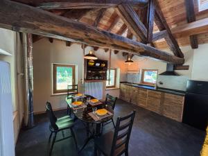 a kitchen and dining room with a table and chairs at Riverside Room Elia Family friendly apartment in Pontboset