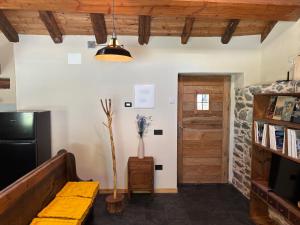 a living room with a couch and a television at Riverside Room Elia Family friendly apartment in Pontboset