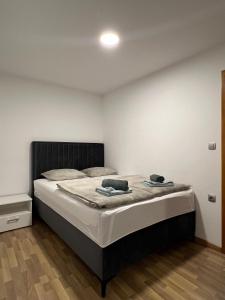 a bedroom with a bed with a black headboard at Iva in Posušje
