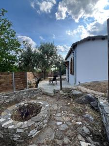 a small white building with a bench next to it at Linos Old Barn in Theológos +6 photos