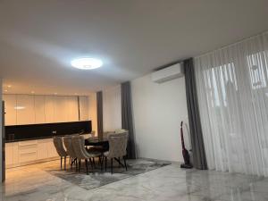 a dining room with a table and chairs at Apartman Provo in Široki Brijeg +3 photos