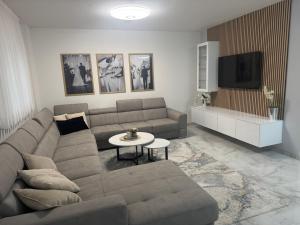 a living room with a couch and a tv at Apartman Provo in Široki Brijeg
